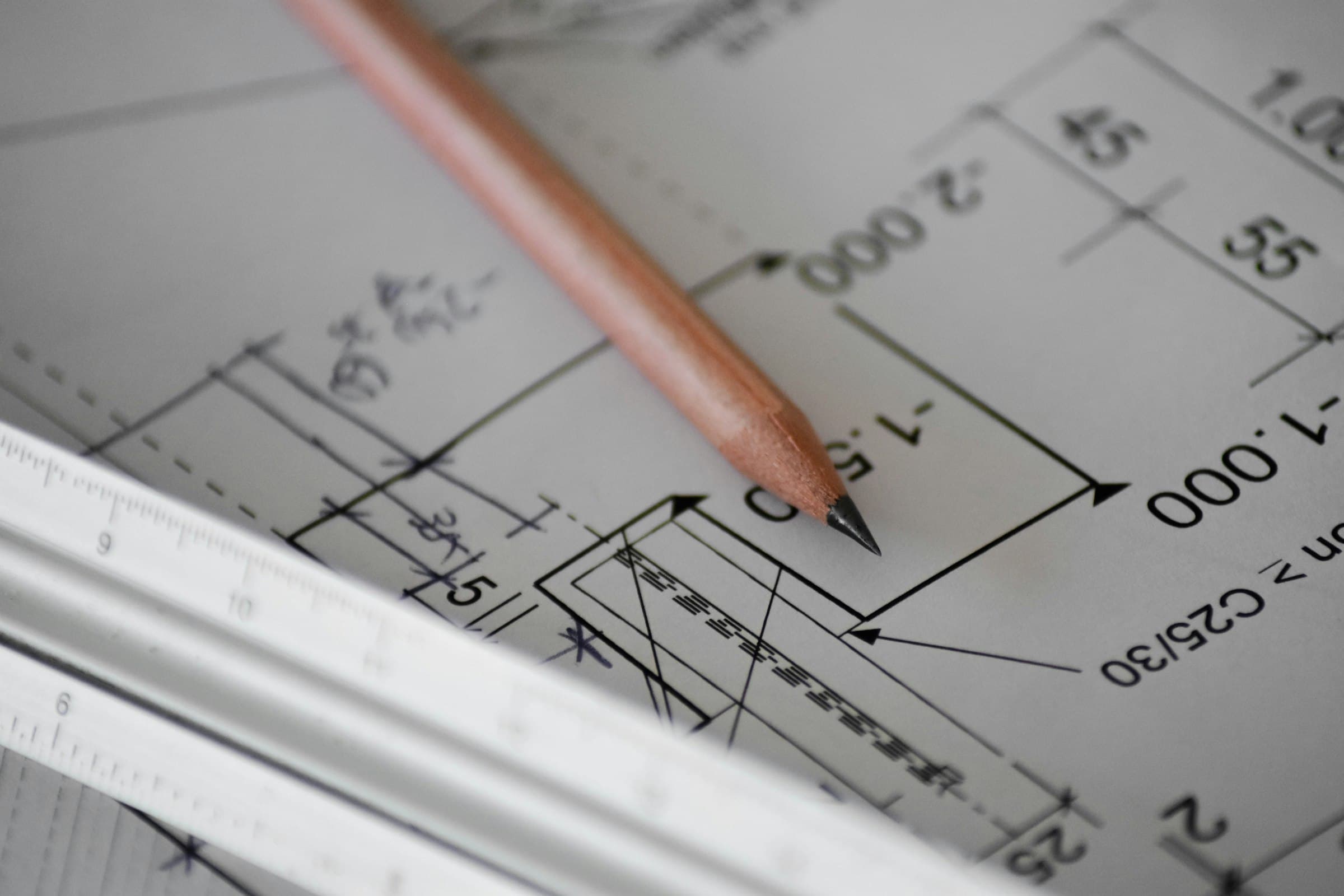 Hand-drafted architectural plan, marked up with a pencil and scale ruler
